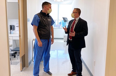 Ryan Dougherty, MBA, RN, assistant executive director of PMUC talking to Mark Binkley, MD, medical director of Hyperbaric Medicine and an Emergency Medicine physician at PPMC